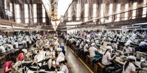 Asian worker sewing in garment factory
