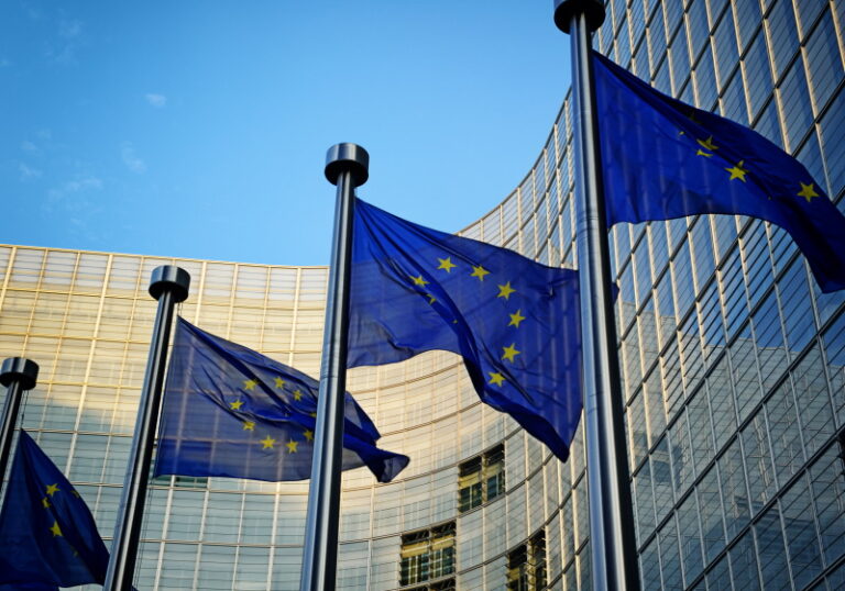 Eu flags in front of european commission building in brussels