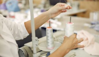 Woman with a thread. Lady in the factory.